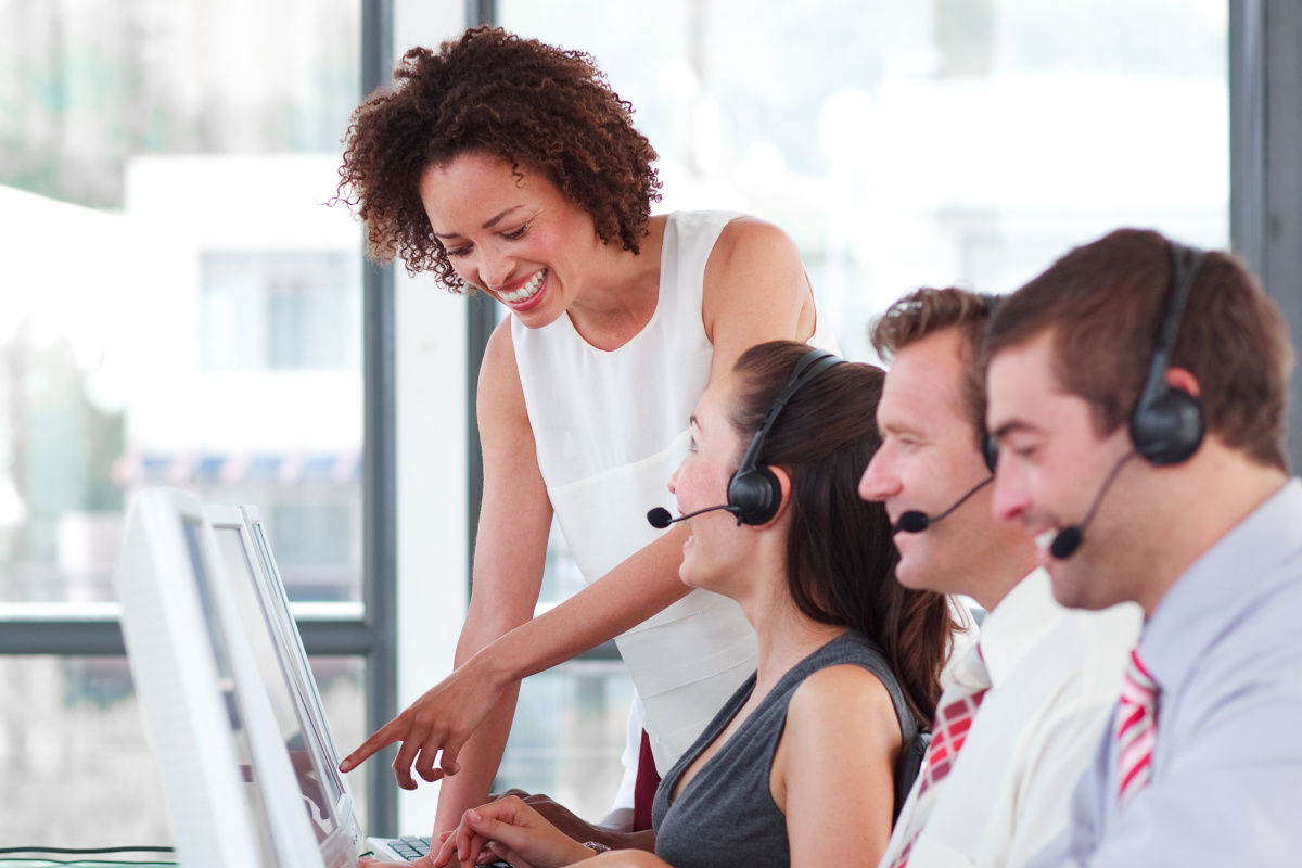 Multiple employees working at a happy call center