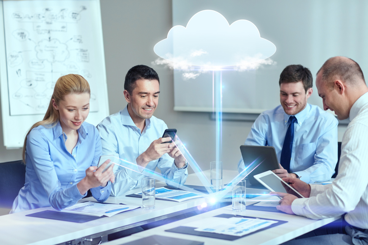 Happy business people working while cloud icon hovers on top of them
