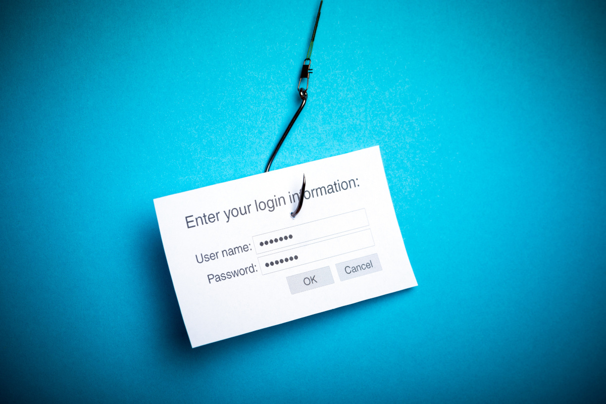 A note card with private information on a fishing hook representing email phishing scams