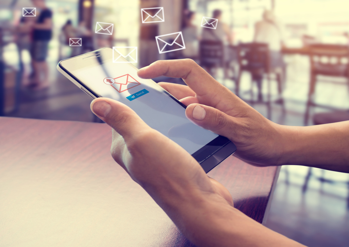 Man sending email via phone
