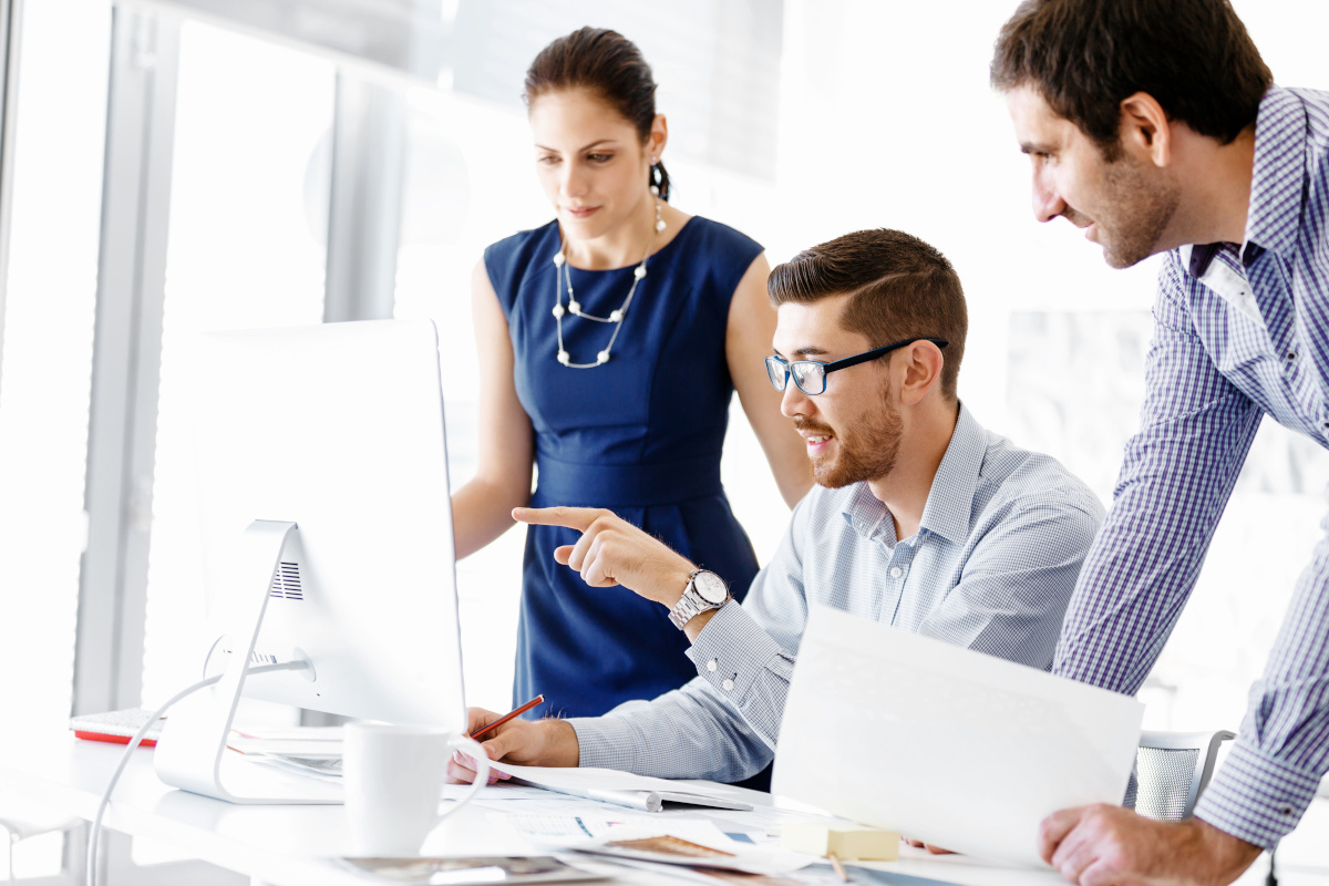 People with a computer and documents working