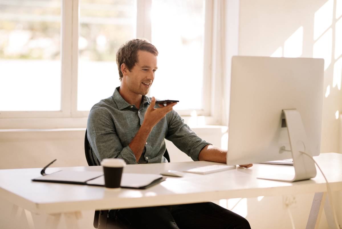 A man working from home talking on his cell phone