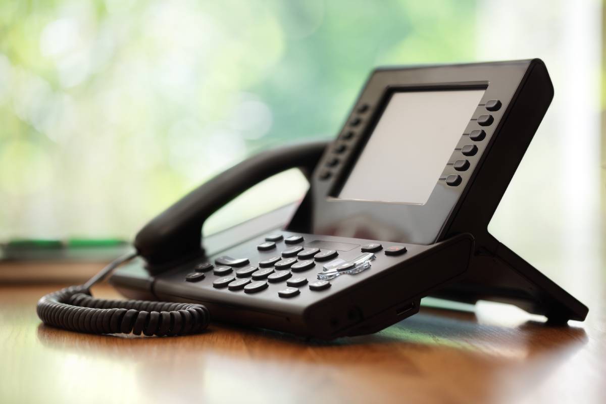 Business phone on brown desk