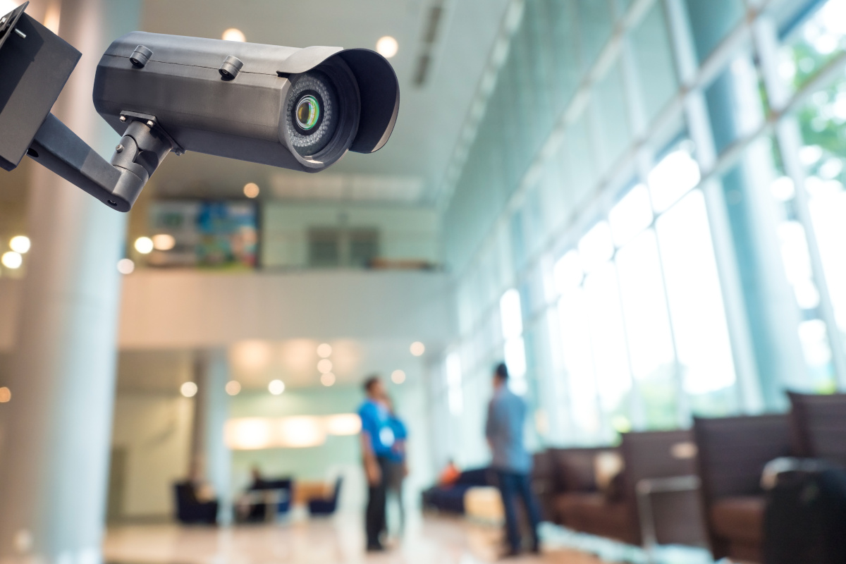 A surveillance camera in a building lobby area